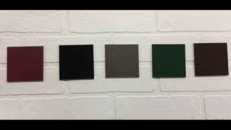 May include: Five color swatches on a white brick wall. The swatches are burgundy, black, gray, green, and brown.
