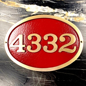 May include: Oval brass house number plaque with a red background. The number 4332 is displayed in gold lettering.