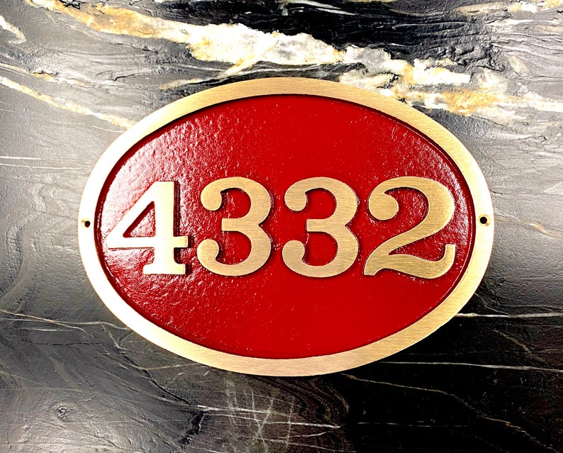 May include: Oval brass house number plaque with a red background. The number 4332 is displayed in gold lettering.