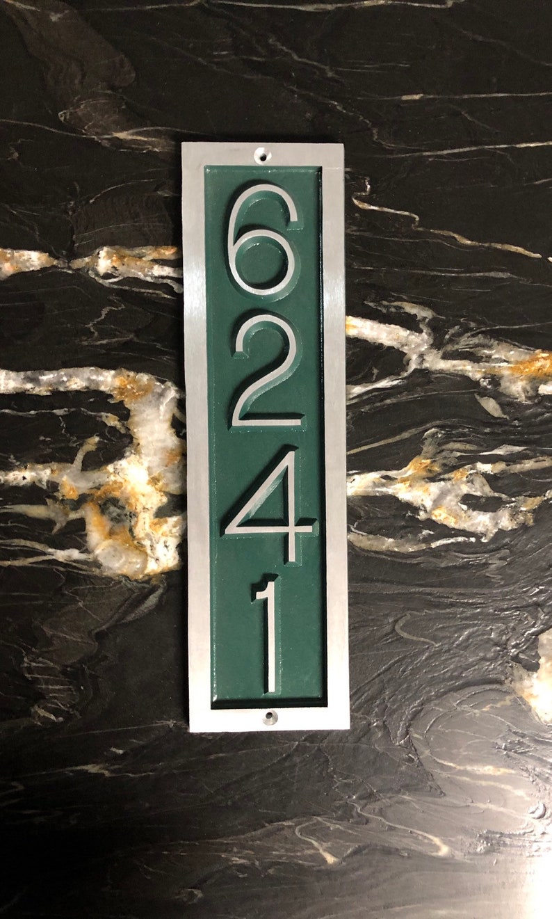 May include: A vertical silver and green house number plaque with the numbers 6241.