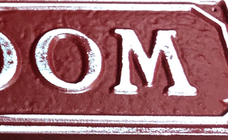 May include: Close-up of a red sign with white lettering that reads "ROOM".