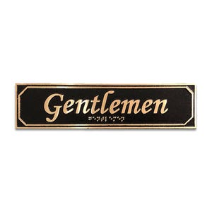May include: A black rectangular sign with gold lettering that reads "Gentlemen".