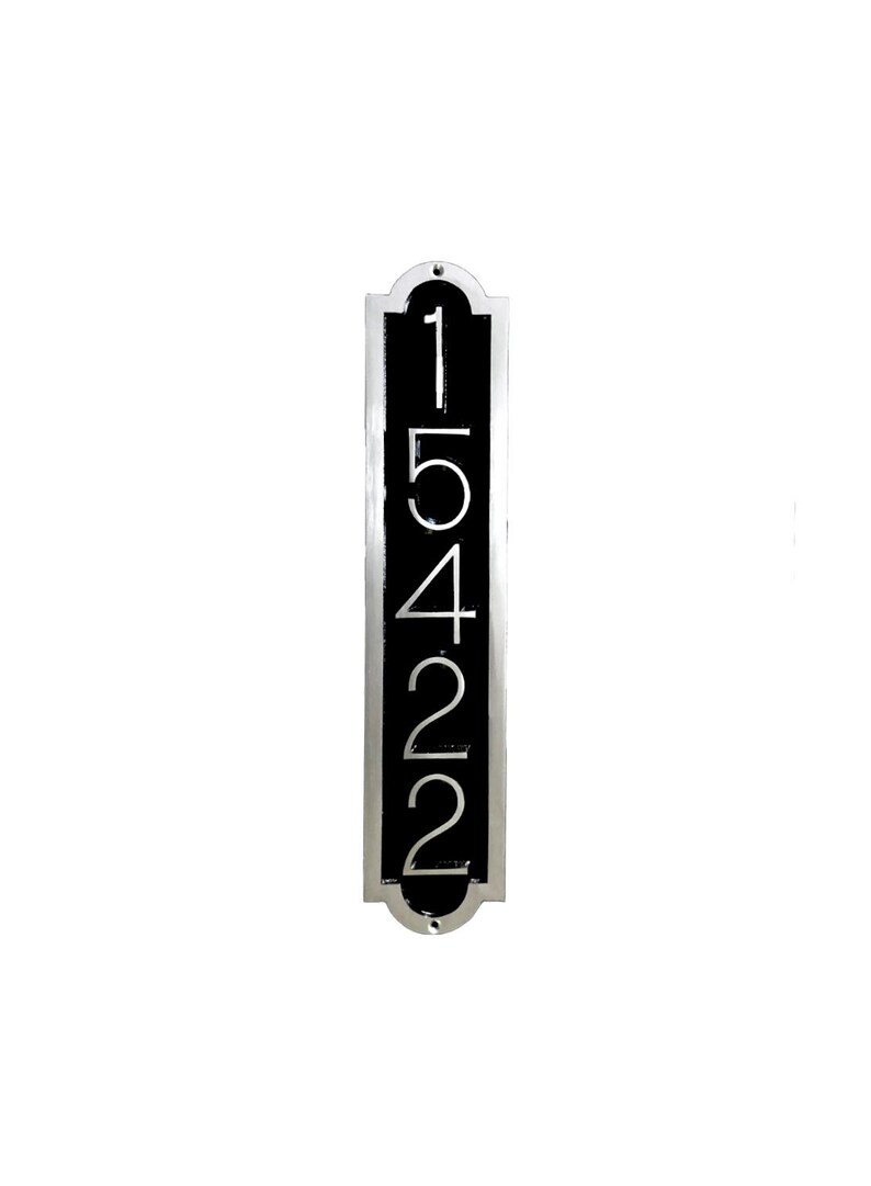 May include: A vertical silver plaque with a black background and the numbers 15422 in white.