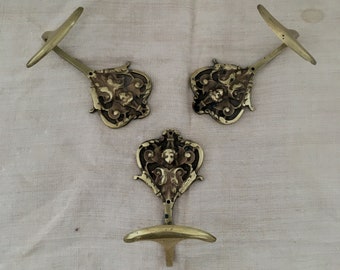 Trio of brass coat hooks