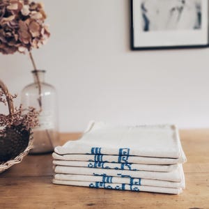 May include: A rustic wooden sign with the text "Welcome to our home" in white lettering. The sign features a distressed finish and a simple, inviting design, perfect for front door decor.