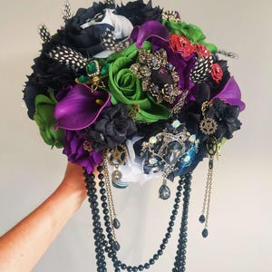 Beetlejuice brooch bridal bouquet alternative wedding flowers gothic black purple feather flowers. Cascading bouquet grunge Punk bouquet