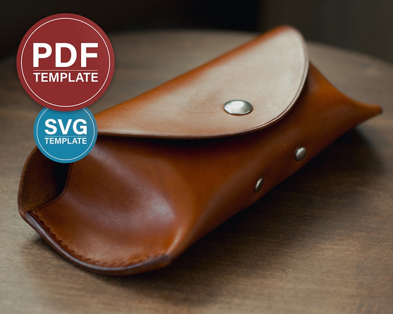 May include: A brown leather glasses case with a flap closure and silver snaps. The case is lying on a wooden surface.  PDF TEMPLATE and SVG TEMPLATE are written on the circles above the case.