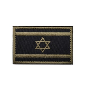 May include: A black and olive green embroidered patch featuring the Israeli flag. The flag has two horizontal olive green stripes and a six-pointed star in the center.
