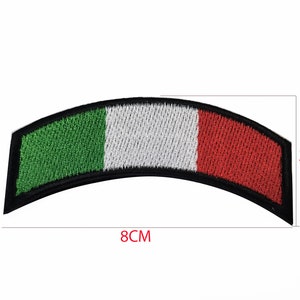 May include: An embroidered Italian flag patch in the shape of a curved rectangle. The patch is green, white, and red with black stitching around the edges. The patch measures 8 inches wide and 3 inches tall.