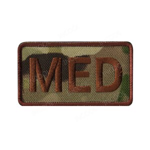 May include: A brown embroidered patch with the word "MED" in a camouflage pattern.