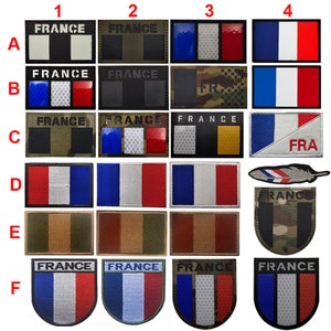 May include: A set of 24 iron-on patches featuring the French flag in various styles and colors. The patches are arranged in six rows of four, with each row labeled with a letter from A to F. The patches are all rectangular except for the ones in the bottom row, which are shaped like shields. The patches are all made of fabric and have a white background with blue and red stripes. Some patches have additional details, such as stars, stripes, or text. The text on the patches includes the word "FRANCE" and the abbreviation "FRA".