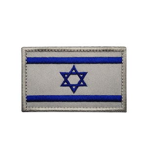 May include: A gray embroidered patch with the Israeli flag. The flag features two blue horizontal stripes and a blue Star of David in the center.
