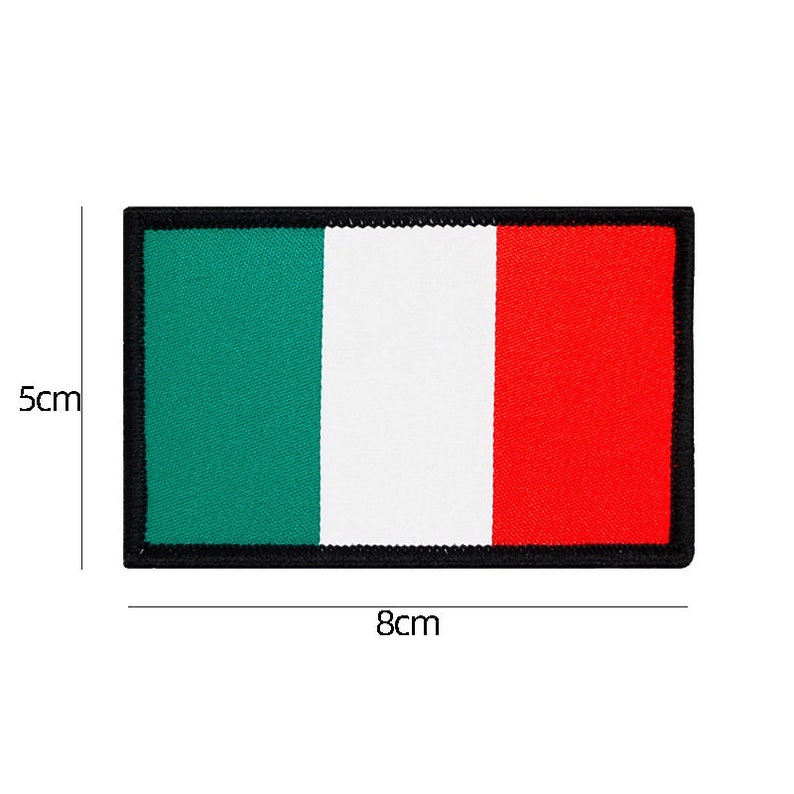 May include: A green, white, and red embroidered patch with a black border. The patch is 5 cm tall and 8 cm wide.