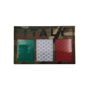 May include: A camouflage fabric patch with the word "ITALY" printed in black letters. The patch features a green, white, and red Italian flag with reflective material.