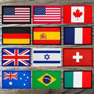 May include: Nine rectangular embroidered patches displaying national flags. Flags include the USA, Canada, Germany, Spain, France, UK, Israel, Switzerland, Australia, Brazil, and Italy. Each patch has a black border.