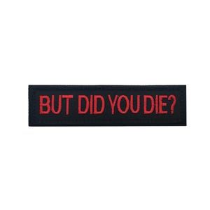 Peut inclure: &Eacute;cusson brod&eacute; noir avec du texte rouge qui dit "BUT DID YOU DIE?"