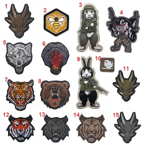 May include: A set of 15 embroidered patches featuring various animal designs, including a dragon, bee, rabbit, wolf, bear, and tiger. The patches are in various colours, including black, white, brown, green, and yellow. The patches are numbered 1 through 15.