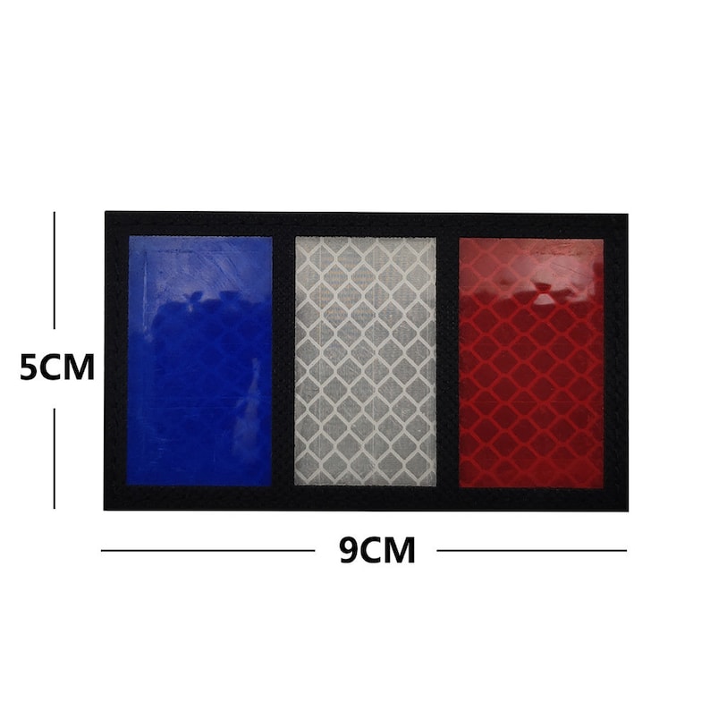 May include: A reflective patch with three vertical stripes in blue, white, and red. The patch is 5 inches tall and 9 inches wide.