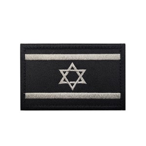 May include: A black embroidered patch with a white Star of David and two white stripes. The patch is a representation of the Israeli flag.