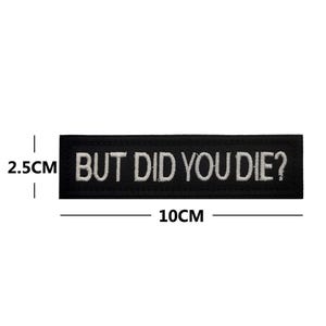 Peut inclure: &Eacute;cusson brod&eacute; noir avec du texte blanc qui dit "BUT DID YOU DIE?" L'&eacute;cusson mesure 2,5 cm de haut et 10 cm de large.