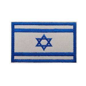 May include: A blue and white embroidered patch featuring the flag of Israel. The patch has a white background with two blue horizontal stripes and a blue Star of David in the center.