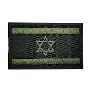 May include: A black and green embroidered patch featuring the Star of David, a symbol of Judaism. The patch has a black background with two green stripes at the top and bottom.