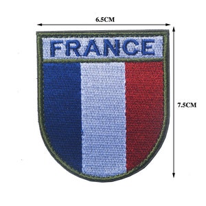 May include: Embroidered patch featuring the French flag in blue, white, and red with the word "FRANCE" above the flag. The patch is 6.5 cm wide and 7.5 cm tall.