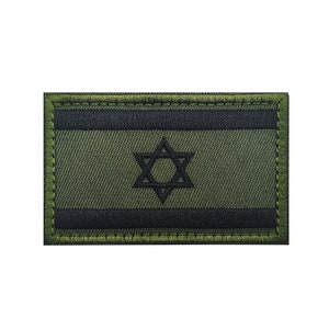 May include: A green and black embroidered patch featuring the Star of David, a symbol of Israel. The patch has a stitched border and is designed for sewing or attaching to clothing or gear.