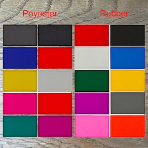 May include: A comparison of fabric swatches in different colours. The swatches are labelled "Polyester" and "Rubber". The colours include black, red, blue, yellow, grey, green, pink, and purple.