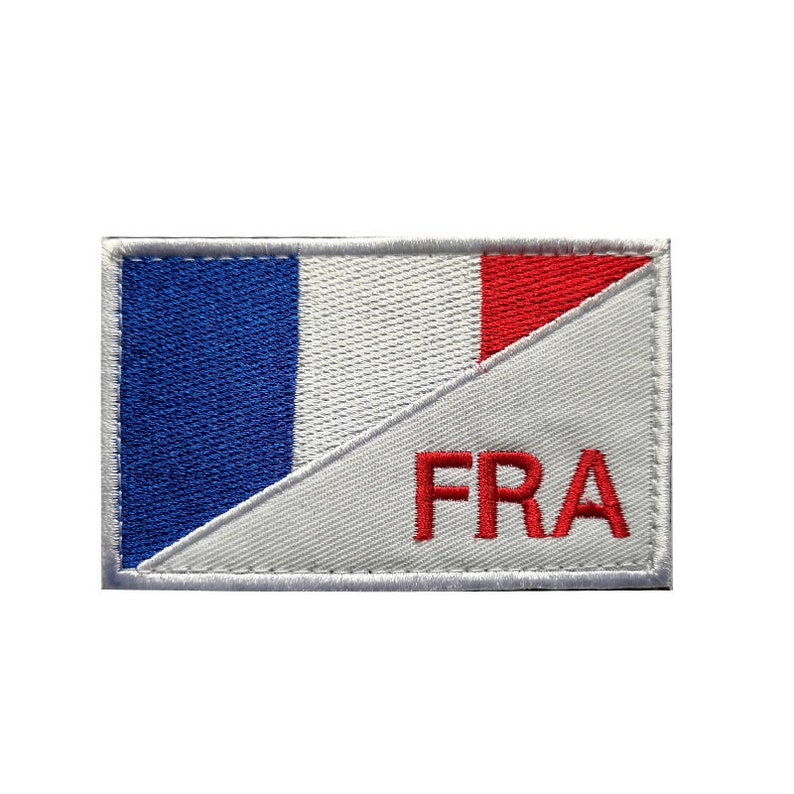 May include: A white embroidered patch with the French flag and the letters "FRA" in red.