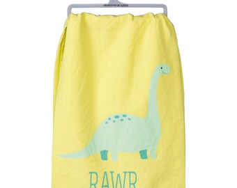 May include: Yellow kitchen towel with a green dinosaur and the word "RAWR" printed on it.