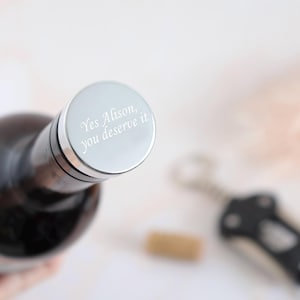 May include: A silver bottle stopper with the engraved message "Yes Alison, you deserve it".