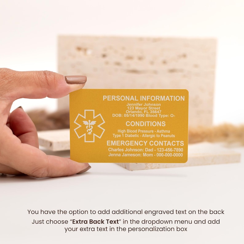 May include: A yellow medical alert card with a star of life symbol. The card includes personal information, medical conditions, and emergency contact information. The text on the card reads: "Personal Information", "Jennifer Johnson", "123 Mayor Street", "Orlando, FL 35647", "DOB: 05/14/1990 Blood Type: O-", "Conditions", "High Blood Pressure - Asthma", "Type 1 Diabetic - Allergic to Peanuts", "Emergency Contacts", "Charles Johnson: Dad - 123-456-7890", "Jenna Jameson: Mom - 000-000-0000".