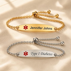 May include: Two medical alert bracelets with adjustable chain links and sliding beads. One gold-tone bracelet is engraved with a red Star of Life symbol and the name Jennifer Johns. One silver-tone bracelet features a red Star of Life and Type I Diabetes.