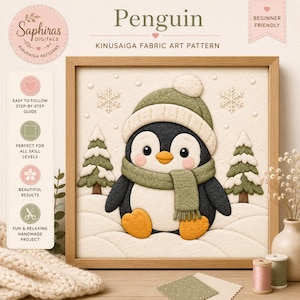 以下が含まれることがあります： 緑の帽子とマフラーを身に着けたペンギンが、2本の松の木と雪の結晶が描かれた雪景色の中にいる、きめこみ手芸のパターン。額装されたアートワークには、PenguinおよびKinusaiga Fabric Art Patternというテキストが含まれています。