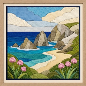 May include: A framed fabric wall art piece depicting a coastal landscape with a sandy beach, turquoise ocean, and rocky cliffs. The scene features green grassy hills in the foreground with clusters of pink flowers and a blue sky with white clouds.