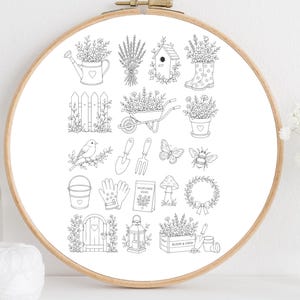 以下が含まれることがあります： 木製の丸い刺繍枠に白い布が張られ、じょうろ、巣箱、手押し車、鳥、蝶、蜂、園芸用具、「Bloom & Grow」と書かれた木箱など、庭をテーマにした黒い線画のイラストが描かれています。