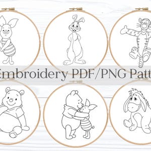 May include: Six embroidery patterns featuring Winnie the Pooh characters, including Piglet, Rabbit, Tigger, Winnie the Pooh, and Eeyore. Each design is a black and white line drawing set within a wooden embroidery hoop. The text "6 Embroidery PDF/PNG Pattern" is displayed.