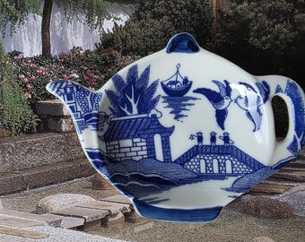 Classic Blue Willow pattern originated in England. This piece is versatile as a spoon rest, a used teabag, mints etc. Time for tea!
