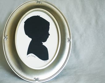Custom child silhouette made from cut paper