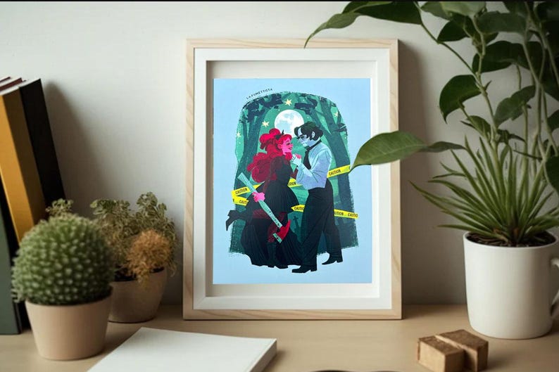 May include: A framed print of a digital illustration of a couple standing in a forest. The woman has red hair and is wearing a black dress. The man is wearing a white shirt and black pants. The background is a blue sky with stars and a moon. The print is surrounded by a white mat and a wooden frame.