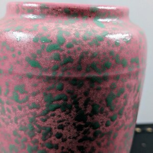 Może przedstawiać: R&oacute;żowy ceramiczny wazon z zielonym, kropkowanym szkliwem.