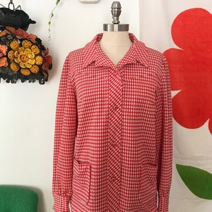 May include: A red and white gingham button-up shirt with long sleeves and two patch pockets. The shirt is on a white mannequin.
