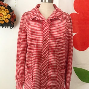May include: A red and white gingham button-up shirt with long sleeves and two patch pockets. The shirt is on a white mannequin.
