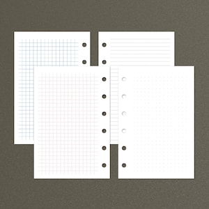 May include: Four sheets of paper with different grid patterns. The sheets are white and have holes punched along the left edge. The top sheet has a grid pattern with small squares. The second sheet has a grid pattern with larger squares. The third sheet has a grid pattern with very small squares. The fourth sheet has horizontal lines.