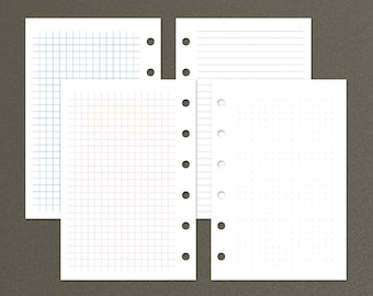 May include: Four sheets of paper with different grid patterns. The sheets are white and have holes punched along the left edge. The top sheet has a grid pattern with small squares. The second sheet has a grid pattern with larger squares. The third sheet has a grid pattern with very small squares. The fourth sheet has horizontal lines.