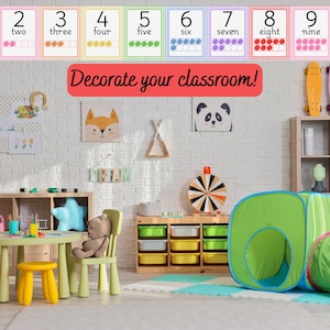 May include: Colorful classroom scene with number flashcards from one to ten. The text "Decorate your classroom!" is displayed in red. The room includes a table, chairs, and a play tent.