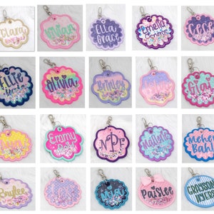 May include: Twenty colorful, personalized, glitter-filled keychains with various names and designs. Each keychain features a clear plastic circle with glitter and a name inside. The keychains are attached to silver key rings.