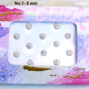 May include: A white card with a pink and purple watercolor background. The card has a white rectangle in the center with 12 silver rhinestones arranged in a grid pattern. The text "No. 1 - 5 mm" is printed at the top of the card.