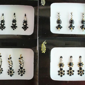 May include: Three sets of black and silver decorative stickers for the face or body. Each set contains three stickers with a floral design.